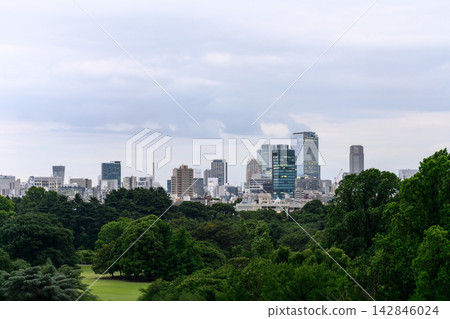 A cityscape of lush forests and modern buildings. A cityscape of lush forests and modern buildings. 142846024