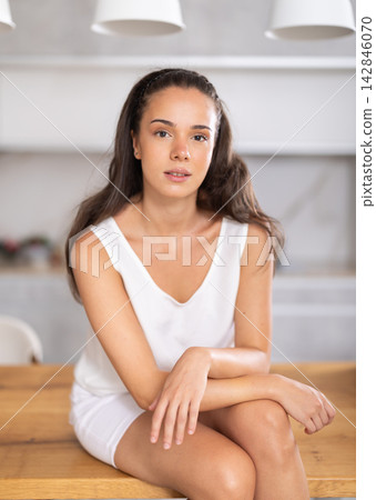Young girl in shorts posing in kitchen at home Young girl in shorts posing in kitchen at home 142846070