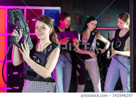 Break in game - portrait of a happy girl with gun for playing laser tag Break in game - portrait of a happy girl with gun for playing laser tag 142846297