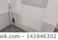 A transparent plastic umbrella placed against the wall – an image of something lost and found. 142846302