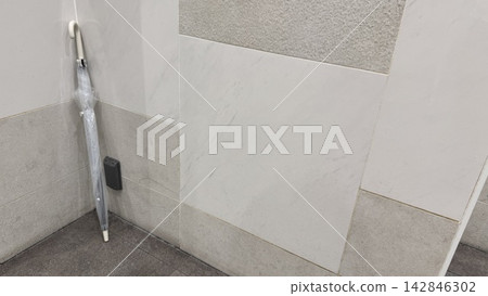 A transparent plastic umbrella placed against the wall – an image of something lost and found. A transparent plastic umbrella placed against the wall – an image of something lost and found. 142846302