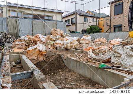 The foundation and waste materials of a demolished house The foundation and waste materials of a demolished house 142846818