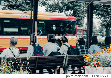 People waiting for the bus at the Hachioji City Hall bus stop People waiting for the bus at the Hachioji City Hall bus stop 142847271