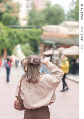 Happy woman traveler travel in Chengdu city. Tourist sightseeing and shopping in Eastern Suburb Memory or Dongjiao Ji Yi. Famous Landmark for tourism attraction in Sichuan, China Happy woman traveler travel in Chengdu city. Tourist sightseeing and shopping in Eastern Suburb Memory or Dongjiao Ji Yi. Famous Landmark for tourism attraction in Sichuan, China 142847410