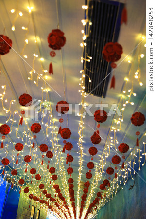 A decorative ceiling background adorned with red ornaments and illuminations. A decorative ceiling background adorned with red ornaments and illuminations. 142848253