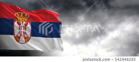 Serbia Flag Waving Against Dark Cloudy Sky Serbia Flag Waving Against Dark Cloudy Sky 142848285