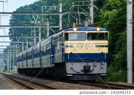 A special event train featuring EF65-500 and 12-series passenger cars travels through the woods of Kitamoto. A special event train featuring EF65-500 and 12-series passenger cars travels through the woods of Kitamoto. 142849153