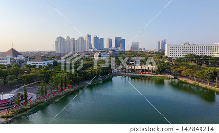 Panoramic view of Danau UNESA lake surrounded by green trees and city skyline in Surabaya East Java. Panoramic view of Danau UNESA lake surrounded by green trees and city skyline in Surabaya East Java. 142849214