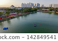 Scenic panoramic view of Danau UNESA lake surrounded by green trees and city skyline in Surabaya, East Java, Indonesia. 142849541