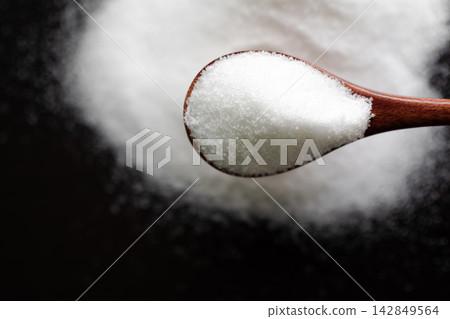 Sugar on spoon top view, texture small pelledts refined sugar organic natural nature ingredient food for cooking, concept for dangerous too much make fat unhealthy calorie overweight diabetes. Sugar on spoon top view, texture small pelledts refined sugar organic natural nature ingredient food for cooking, concept for dangerous too much make fat unhealthy calorie overweight diabetes. 142849564