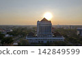 August 29, 2026. Surabaya, Indonesia. Aerial view of UNESA Rectorate building during golden hour sunset with city skyline in Surabaya Indonesia. 142849599