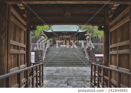 Japan April 29 2026 Framed Toshogu shrine hall through wooden gate 142849891