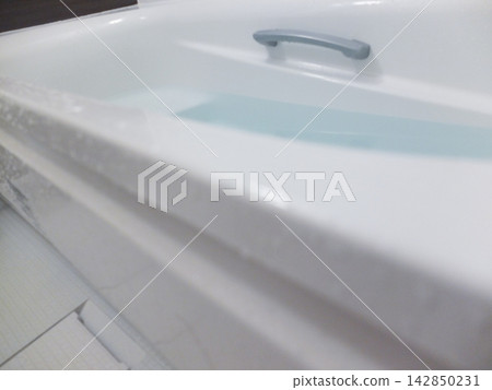 Bathtub filled with hot water Bathtub filled with hot water 142850231