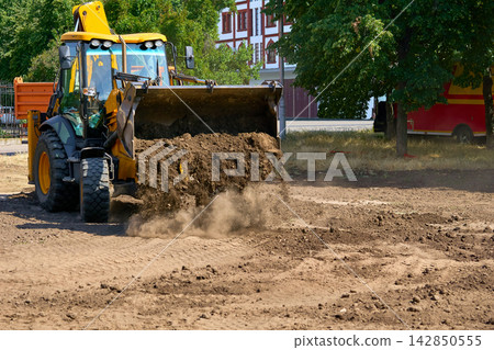 Work.Bulldozer excavator bucket picking up the ground,soil on road repair Work.Bulldozer excavator bucket picking up the ground,soil on road repair 142850555