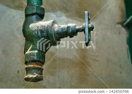 Plumbing.Old water faucet valve in basement Plumbing.Old water faucet valve in basement 142850706