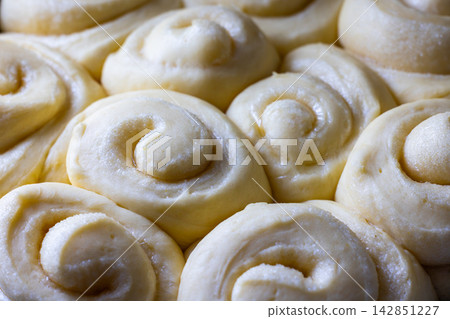 Close-up of Uncooked Sweet Rolls Dough in Baking Pan Close-up of Uncooked Sweet Rolls Dough in Baking Pan 142851227