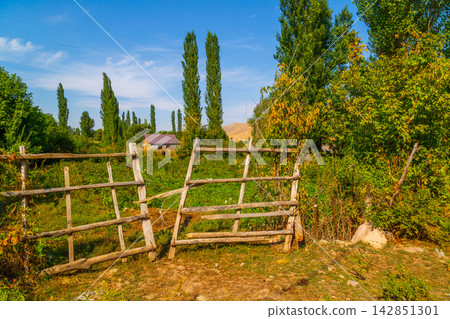 Rustic Wooden Fence and Rural Landscape in Kyrgyzstan Rustic Wooden Fence and Rural Landscape in Kyrgyzstan 142851301