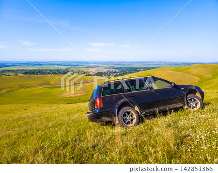 Station Wagon on Grassy Hillside Overlooking Valley Station Wagon on Grassy Hillside Overlooking Valley 142851366