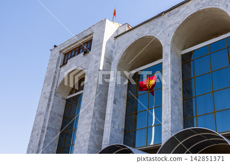 Reflection of Kyrgyzstan National Flag on Government Building Reflection of Kyrgyzstan National Flag on Government Building 142851371