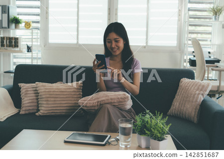 Woman enjoying life at home, promoting healthy eating, wellness, and a balanced lifestyle. Concept of natural nutrition, mindfulness, and modern healthy living. Woman enjoying life at home, promoting healthy eating, wellness, and a balanced lifestyle. Concept of natural nutrition, mindfulness, and modern healthy living. 142851687