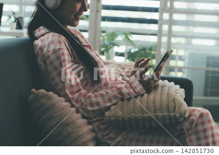 Woman enjoying life at home, promoting healthy eating, wellness, and a balanced lifestyle. Concept of natural nutrition, mindfulness, and modern healthy living. Woman enjoying life at home, promoting healthy eating, wellness, and a balanced lifestyle. Concept of natural nutrition, mindfulness, and modern healthy living. 142851730