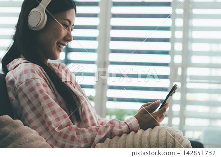 Woman enjoying life at home, promoting healthy eating, wellness, and a balanced lifestyle. Concept of natural nutrition, mindfulness, and modern healthy living. Woman enjoying life at home, promoting healthy eating, wellness, and a balanced lifestyle. Concept of natural nutrition, mindfulness, and modern healthy living. 142851732