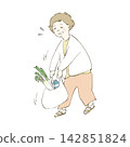 A middle-aged woman struggling with heavy shopping bags. 142851824