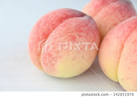 A close-up of a fresh Hanayome peach with beautiful downy hairs. A close-up of a fresh Hanayome peach with beautiful downy hairs. 142851978