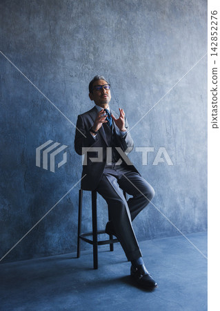 A standing businessman A standing businessman 142852276