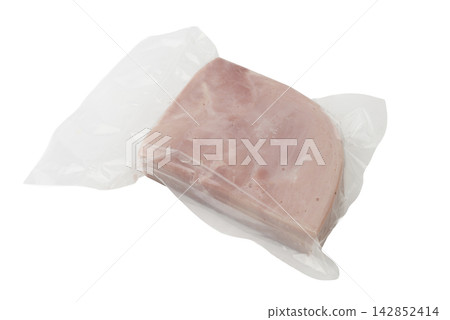 A slice of pink ham is vacuum-sealed in clear plastic packaging. A slice of pink ham is vacuum-sealed in clear plastic packaging. 142852414