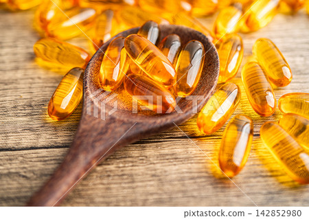 Fish oil or Cod liver oil gel in capsules with omega 3 vitamins, supplementary healthy food. Fish oil or Cod liver oil gel in capsules with omega 3 vitamins, supplementary healthy food. 142852980