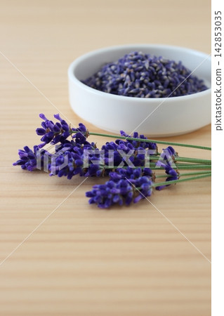 A natural image of dried lavender flowers and a bouquet. A natural image of dried lavender flowers and a bouquet. 142853035