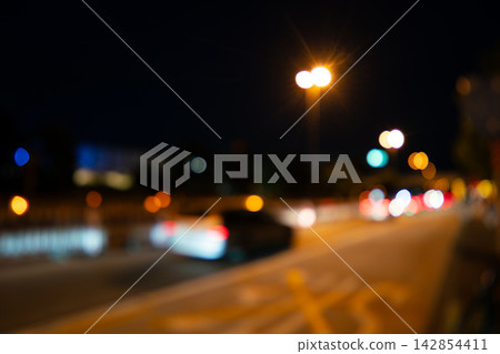 Abstract background of Night city street with colorful bokeh lights and moving car Abstract background of Night city street with colorful bokeh lights and moving car 142854411