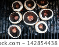 Seasoned portobello mushrooms grilling over hot coals Seasoned portobello mushrooms grilling over hot coals 142854438