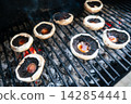 Seasoned portobello mushrooms grilling over hot coals Seasoned portobello mushrooms grilling over hot coals 142854441