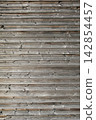 Aged wood wall panels featuring detailed grain patterns and vintage rustic wooden surface texture Aged wood wall panels featuring detailed grain patterns and vintage rustic wooden surface texture 142854457
