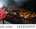 Delicious BBQ Chicken Wings Grilling Over Hot Coals in Backyard Delicious BBQ Chicken Wings Grilling Over Hot Coals in Backyard 142854459