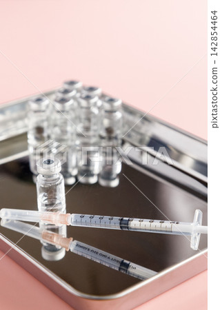 Vaccination image: A metal tray containing a 1ml syringe and vial. Vaccination image: A metal tray containing a 1ml syringe and vial. 142854464