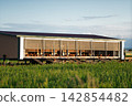 Modern mobile chicken coop with chickens roaming freely on green pastures Modern mobile chicken coop with chickens roaming freely on green pastures 142854482