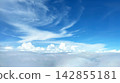 A breathtaking view of a sea of clouds and blue sky from an airplane window, a fantastical landscape of clouds spreading across the sky. 142855181