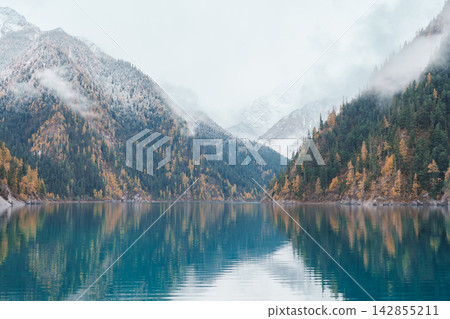 Scenery Jiuzhaigou national park in Sichuan, China. Beautiful Long lake and snow mountain in Autumn season. Famous Landmark and Vacation near Chengdu, China. Asia travel concept Scenery Jiuzhaigou national park in Sichuan, China. Beautiful Long lake and snow mountain in Autumn season. Famous Landmark and Vacation near Chengdu, China. Asia travel concept 142855211