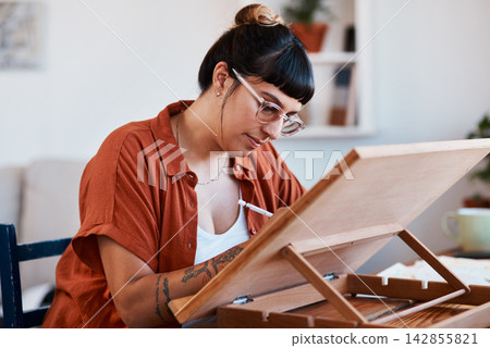 Art, creative and project with woman in home for design, expression or inspiration on weekend. Draft, pencil and wooden table with artist illustrator drawing in apartment for break, hobby or sketch Art, creative and project with woman in home for design, expression or inspiration on weekend. Draft, pencil and wooden table with artist illustrator drawing in apartment for break, hobby or sketch 142855821