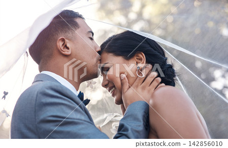 Kiss, couple and happy on wedding day as celebration for love, commitment and success on marriage. Ceremony, woman and man at event as reception together, achievement or goal with care on honeymoon Kiss, couple and happy on wedding day as celebration for love, commitment and success on marriage. Ceremony, woman and man at event as reception together, achievement or goal with care on honeymoon 142856010