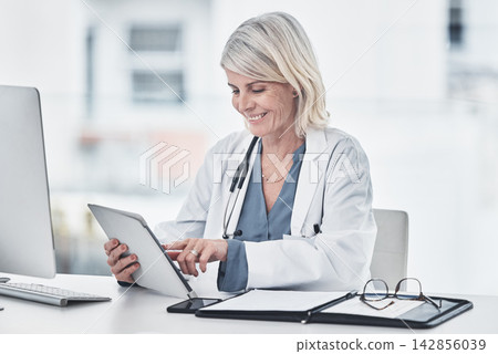 Happy, doctor and woman with tablet in office for patient data, medical trending news and applications for appointment schedule. Mature, nurse and online in hospital for digital records or notes. Happy, doctor and woman with tablet in office for patient data, medical trending news and applications for appointment schedule. Mature, nurse and online in hospital for digital records or notes. 142856039
