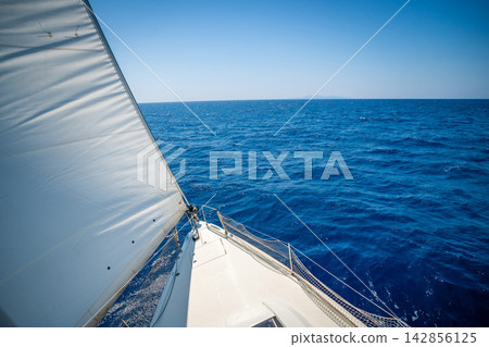 View from the mast down to the bow of a sailing yacht moving under full sails near Croatia. Freedom, adventure, yachting lifestyle and dynamic sea travel. View from the mast down to the bow of a sailing yacht moving under full sails near Croatia. Freedom, adventure, yachting lifestyle and dynamic sea travel. 142856125