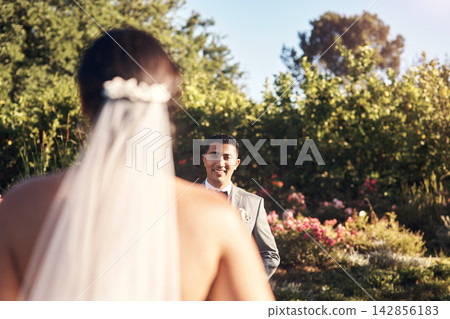 Outdoor, wedding and bride walking to groom, veil and man with smile for wife, celebration and commitment. Garden, venue and event for marriage of people, couple and together with love in reception Outdoor, wedding and bride walking to groom, veil and man with smile for wife, celebration and commitment. Garden, venue and event for marriage of people, couple and together with love in reception 142856183