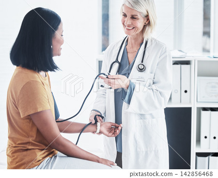 Blood pressure, happy doctor and patient in office for healthcare, check up and consultation with gp. Woman, female nurse and examination in hospital for wellness, medicare and trust in appointment 142856468