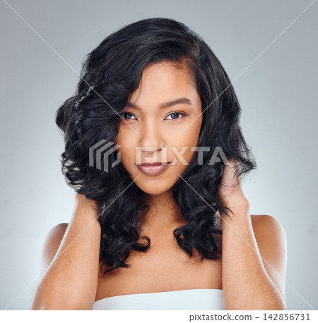 Hair care, woman and portrait in studio for beauty with curly treatment, shampoo shine or glowing texture. Model, person and face with confidence for skincare, cosmetics or haircut on gray background Hair care, woman and portrait in studio for beauty with curly treatment, shampoo shine or glowing texture. Model, person and face with confidence for skincare, cosmetics or haircut on gray background 142856731