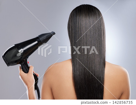 Girl, back and hairdryer in studio for hair grooming or styling, haircare and beauty routine for wellness or keratin treatment. Woman, tool and isolated on white background for result, shine and glow 142856735