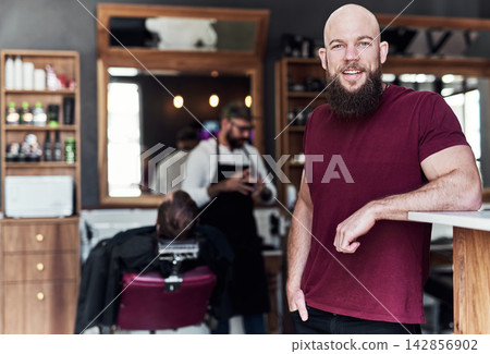 Hair care, confidence and portrait of man in barbershop with smile, people and skills at trendy small business. Style, face and happy barber with professional grooming service, haircut and trim. Hair care, confidence and portrait of man in barbershop with smile, people and skills at trendy small business. Style, face and happy barber with professional grooming service, haircut and trim. 142856902